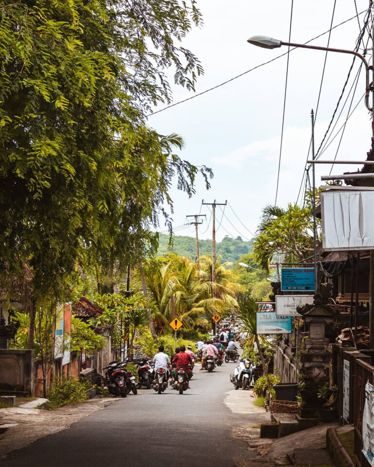 indonesian-men-on-scooters-driving-down-road-on-nusa-lembongan-compressed